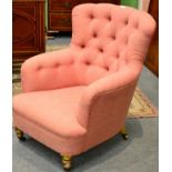 A Victorian Easy Chair, circa 1870, recovered in pink button-back cotton fabric with overstuffed