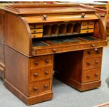 ~ A Victorian Mahogany Cylinder Desk, 3rd quarter 19th century, with three-quarter gallery above a