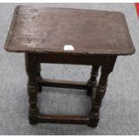 A 17th Century Oak Joint Stool, the four-pegged rectangular top above a plain frieze, raised on