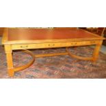 An Early 20th Century Oak Library or Boardroom Table, with inset red leather top above eight