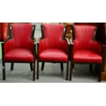 ^ A Set of Three 1930s Armchairs, recovered in red close-nailed leatherette, 54cm wide