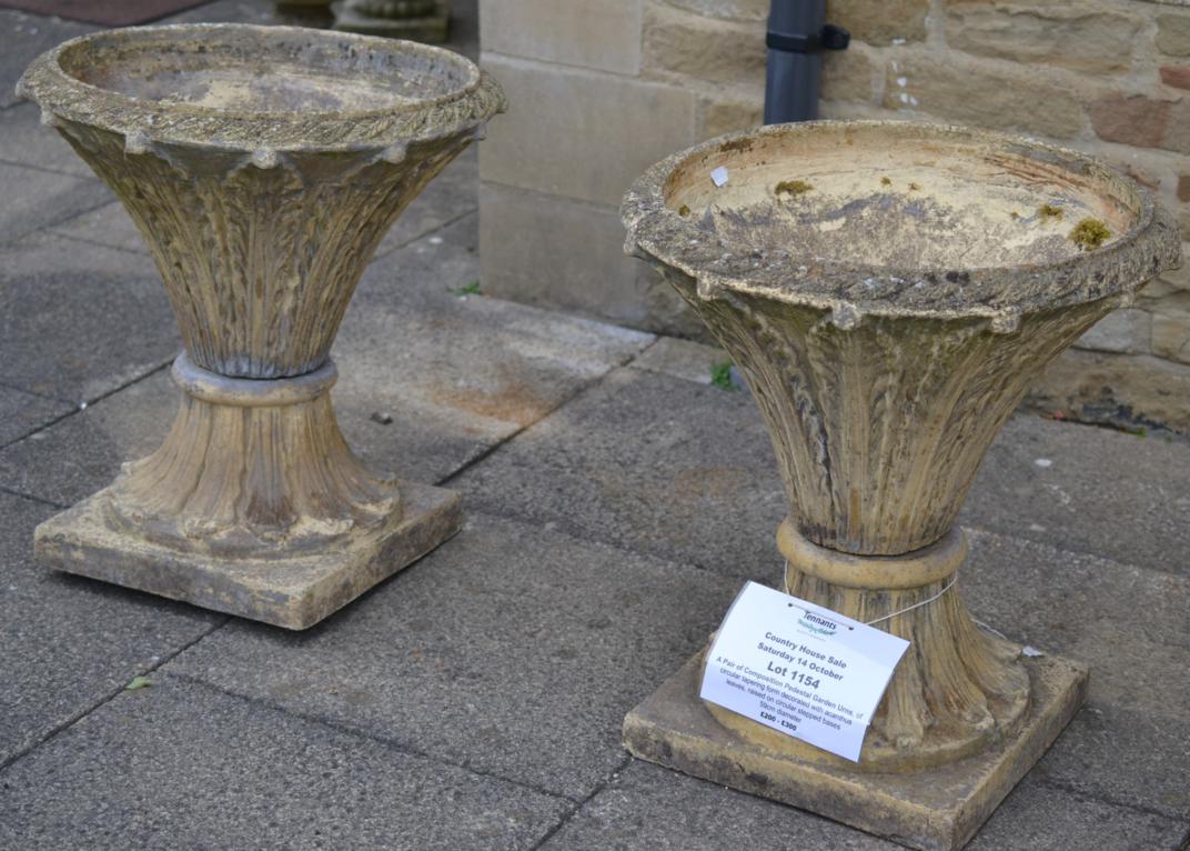 A Pair of Composition Pedestal Garden Urns, of circular tapering form decorated with acanthus