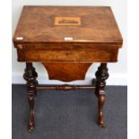 A Victorian Figured Walnut Games and Sewing Table, circa 1870, the hinged lid inlaid with a