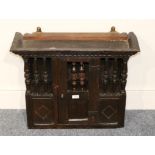 A Mid 17th Century Oak Wall Hanging Joined Mural Livery Cupboard, integral cornice, central door,