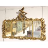 ^ A Giltwood and Gesso Overmantel Mirror, with an acanthus C scroll frame surmounted