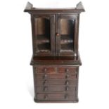 A Victorian Mahogany Miniature Cabinet on Chest, late 19th century, the cavetto cornice over