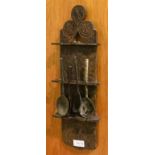 A 16th Century Oak Spoon Rack, of shaped form with decorative roundels, all-over carved