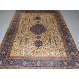 Tabriz Carpet The cream field of trees, birds and plants around an indigo pole medallion framed by