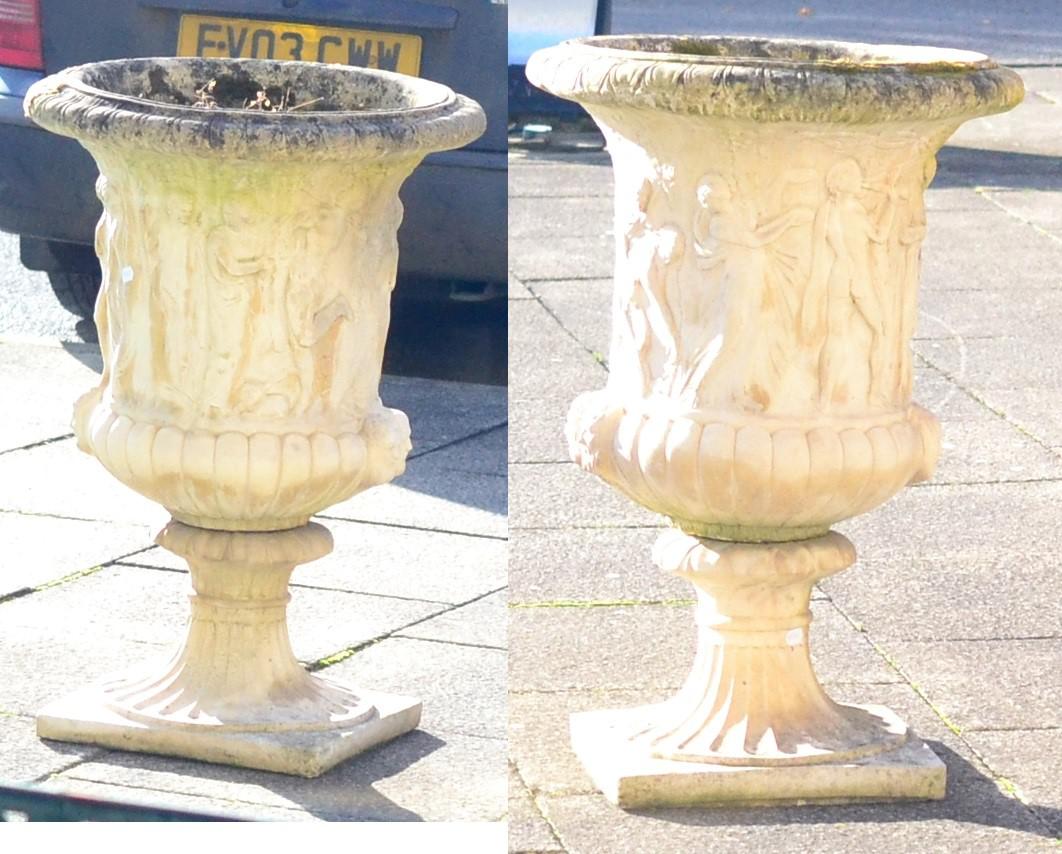 Pair of Weathered Stone Pedestal Urns of Campana Form, decorated with scenes of classical figures