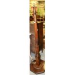 ~ A Carved Mahogany Standard Lamp, the canted column support with square form base and raised on