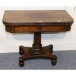 ~ A Regency Rosewood Foldover Card Table, with gadrooned border above a tabulated frieze, raised