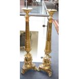 A Pair of Gilt and Gesso Candlestands, the acanthus decorated tapering supports with triform bases