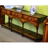 A George III Oak Low Dresser, late 18th century, with three frieze drawers above an arched apron,