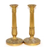 A pair of French Empire style gilt bronze candlesticks