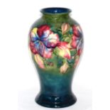 A Walter Moorcroft pottery baluster vase, Hibiscus pattern, painted and impressed marks and with