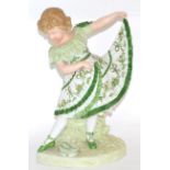 A German bisque figure of a child in green dress