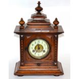 A Victorian walnut cased striking mantel clock, movement backplate stamped Junghans