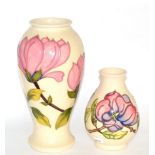 Two Moorcroft Magnolia vasesLargest vase 31.5cm. Each vase crazed throughout otherwise in good