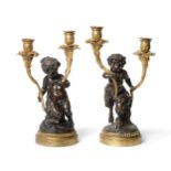 A Pair of French Gilt and Patinated Bronze Candelabra, late 19th century, after a model by Louis-