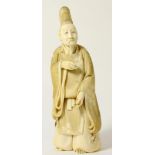 A Japanese Ivory Okimono, Meiji period (1868-1912), as a sage in flowing robes, signed to red