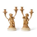 A Pair of French Gilt Bronze Twin-Light Candelabra, in Louis XVI style in the manner of Clodion,