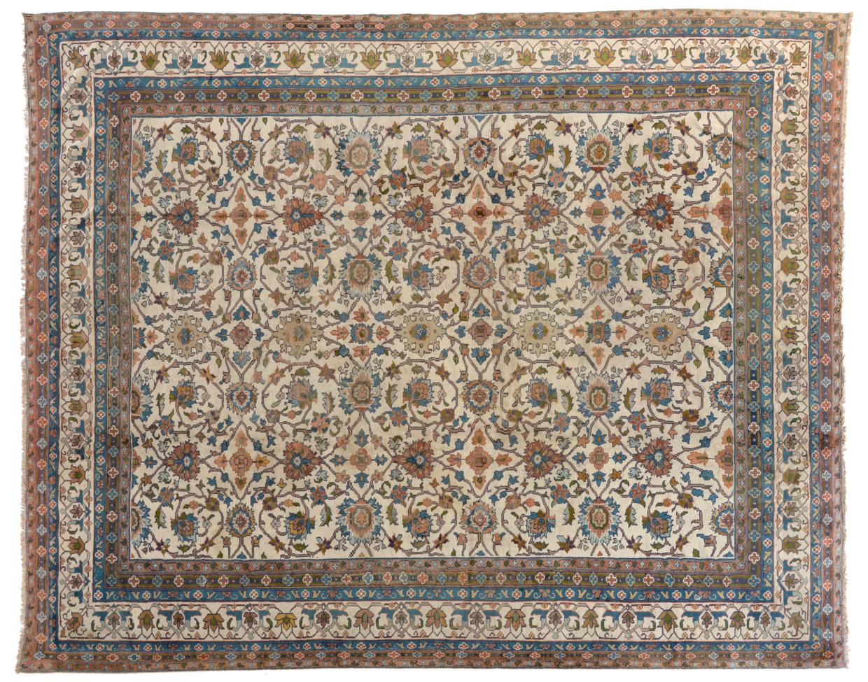 Indian Carpet of unusual size, circa 1920 The ivory field with an allover design of scrolling