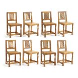 Mouseman: A Set of Eight Robert Thompson English Oak Lattice Back Dining Chairs, with tan cow hide