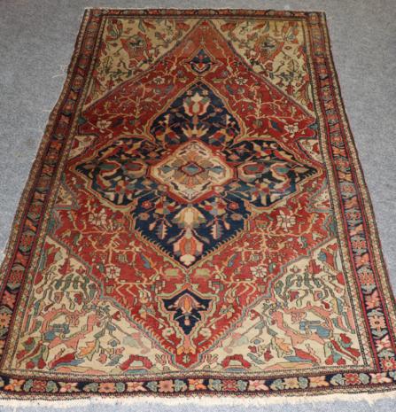 Saroukh Rug West Iran, circa 1910 The madder lozenge field of angular vines centred by an indigo and