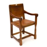 Mouseman: A Robert Thompson English Oak Armchair, panel-back and shaped arms, upholstered tan hide