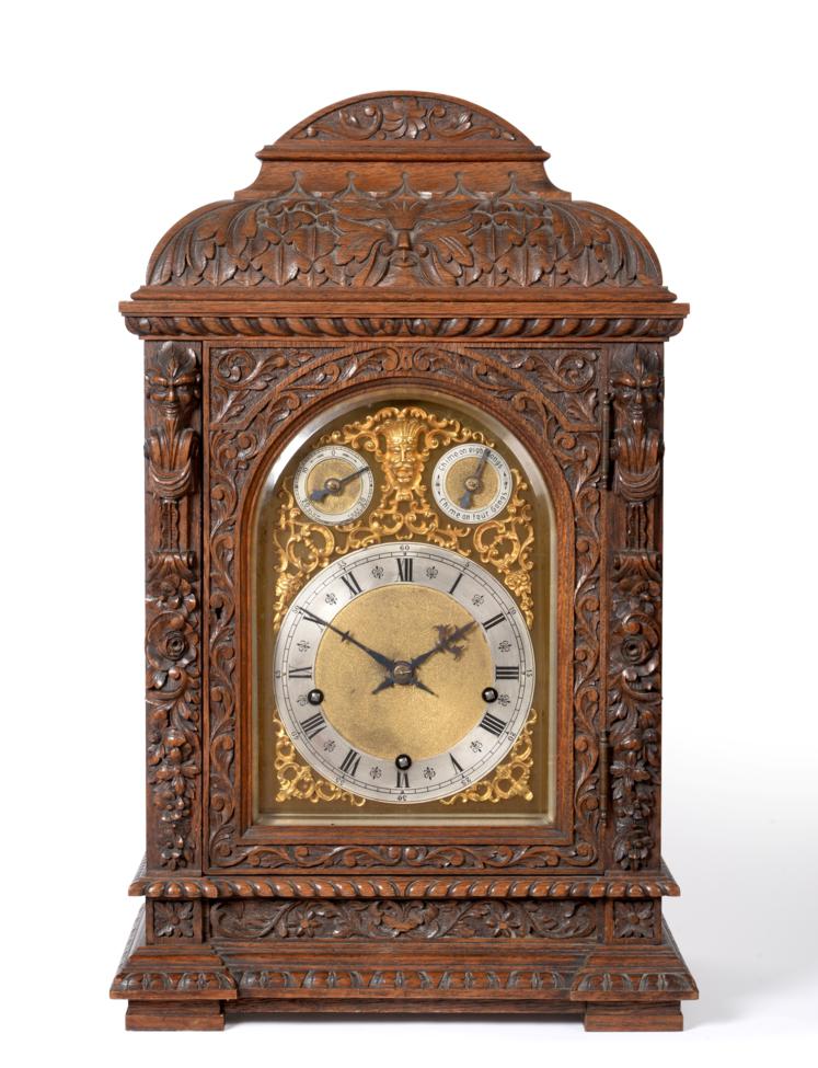 A Carved Oak Chiming Table Clock, circa 1890, elaborately carved case with scroll, floral and mask