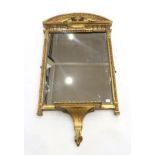 A Regency Gilt and Gesso Wall Mirror, early 19th century, the architectural pediment above an urn