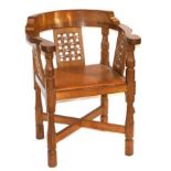 Mouseman: A Robert Thompson Oak Monk's Chair, with curved back and shaped arms, over three lattice