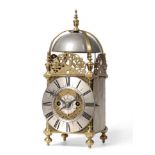 A Brass Striking Lantern Clock, four posted case with side doors and side frets, silvered chapter