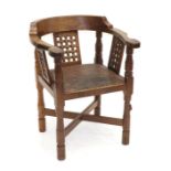 Mouseman: A Robert Thompson English Oak Monk's Chair, with curved back and shaped arms, over three