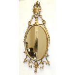 A George III Gilt and Gesso Oval Pier Glass, late 18th century, the ropetwist frame surmounted by an