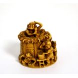 A Japanese carved ivory netsuke, Meiji period, depicting figures and demons bathing, signed to base