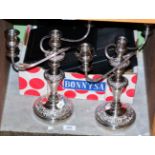 A pair of silver plated three light candelabra; together with various boxed flatware