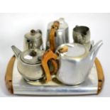 A Tudric pewter for Liberty & Co four piece bachelor's teaset, planished finish; together with a '