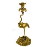 A Regency style gilt brass candlestick in the form of a crane with crown, naturalistic base,