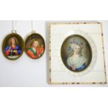 An early 20th century portrait miniature in contemporary piano key frame; together with two