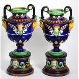 A pair of majolica Minton style pedestal vases decorated with masks, 35cm high