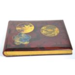 A Japanese lacquer photograph album circa 1900, containing hand tinted topographical views of