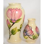 Two Moorcroft Magnolia vasesLargest vase 31.5cm. Each vase crazed throughout otherwise in good