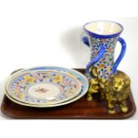 A Cotswold Pottery lion, stamped; together with two Maiolica tin glazed dishes and a tyg (4)