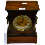 A rosewood striking mantel clock, circa 1900, with drop ring lion mask handles