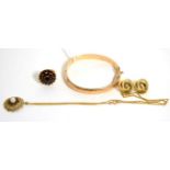 A 9 carat gold bangle, a pair of knot earrings, a garnet ring and a garnet pendant Bangle - 8.65g