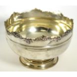 A large silver punch bowl, with shaped foliate rim on circular foot