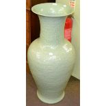 A very large Oriental celadon glazed vase, moulded in relief with dragons, modern