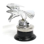 A 1933 Alvis Eagle Car Mascot, with outstretched wings standing on a rocky base mounted on a