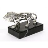 A Peugeot Chrome Car Mascot Modelled as a Lion, mounted on a black and white veined marble